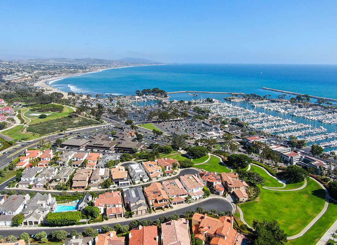 Insurance Solutions - Aerial View of Luxury Homes and Businesses Along the Coast in Southern California Surrounded by Green Foliage